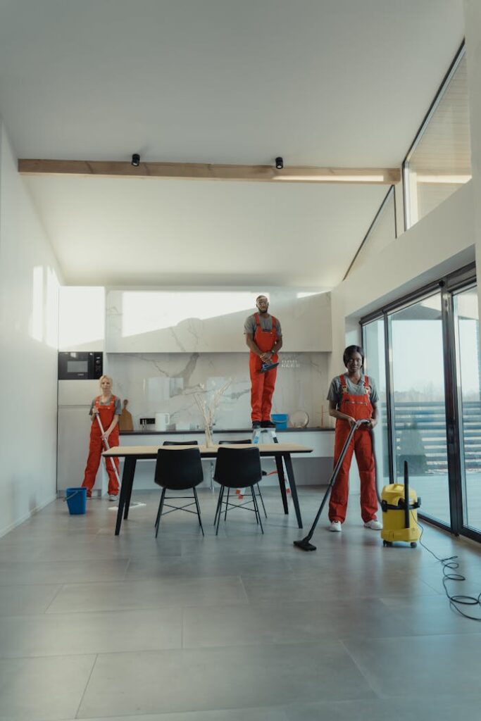 Team of professional cleaners working in a spacious, modern indoor setting.